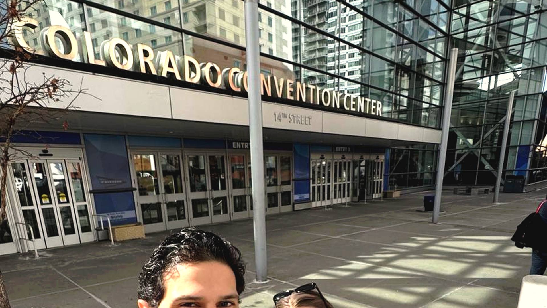 Andre De Souza and Liza, founders of CivicsPath, in convention center setting